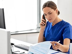 photo of female doctor or nurse on the phone