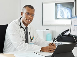 photo of a doctor and computer