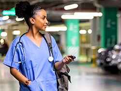 photo of Female nurse looking for a car in the parking lo