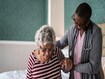 photo of Nurse helping a senior woman