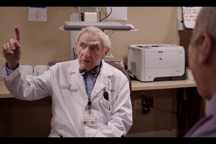 photo of Tucker talking with Keyvan Ravakhah