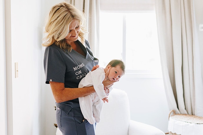 photo of Laura Hunter demonstrates a baby care technique