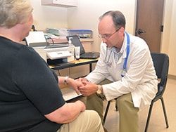 photo of James Gore examines a patient