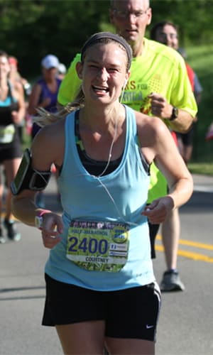 photo of Courtney Carlson Strother, MD, running a half marathon.