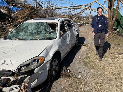 photo of Dr. John Roberts conducts an initial damage assessment after a series of tornadoes tore through Kentucky.