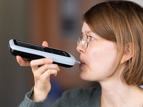 photo of  A user performs a breath measurement with the acetone analyzer.