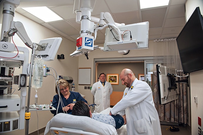 photo of Dr Bassin works with a patient at the EC3