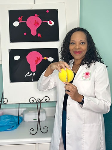photo of Donna Adams-Pickett, MD, PhD, uses a sponge ball to help show teens how properly to insert a tampon. 