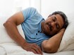 mature man sleeping in bed