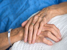 photo of Crossed hands of a sick elderly woman