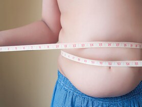 photo of boy measuring waist