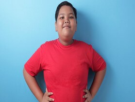 photo of Asian obese boy smiling at camera