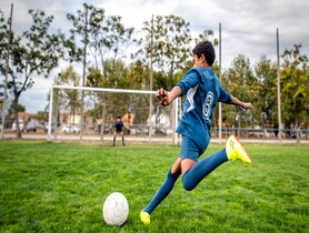 photo of teen playing soccer