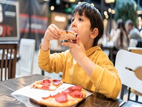 photo of Child Eating Pizza